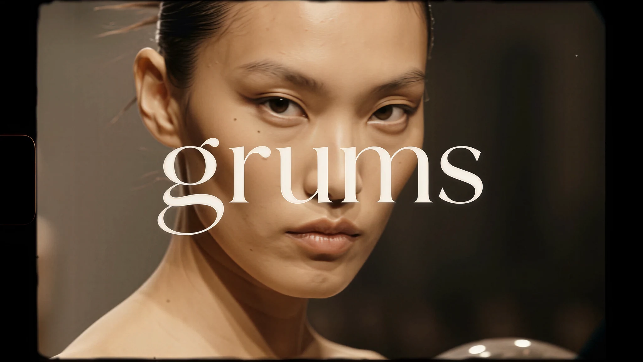 The original supplied Grums portrait with the complete ivory wordmark