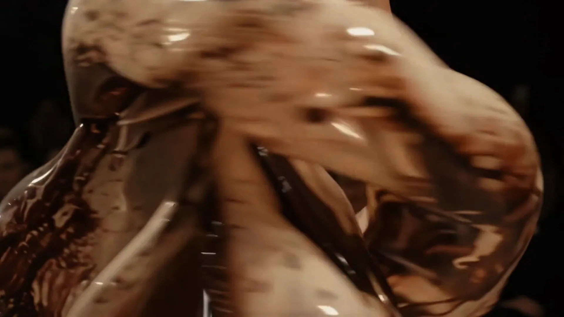 Close on a gown of clear glass forms filled with brown foam